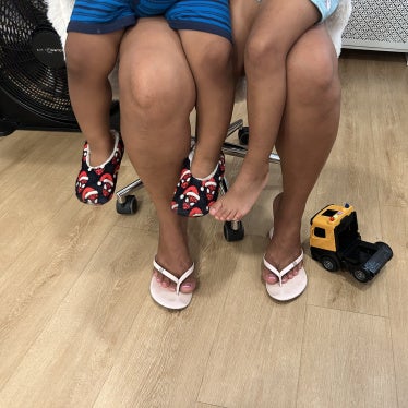An asylum seeker who has lived in the US for four years holds her two US citizen children, ages 2 and 4, in her lap, September 2026. 