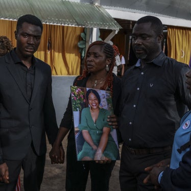 Family members hold a portrait of Geraldine Buweh Atsie, a victim of femicide, at the Jamot Hospital in Yaounde on September 18, 2026.