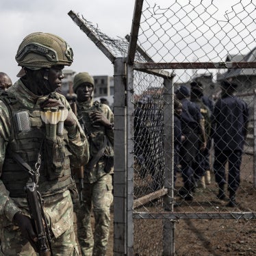 A member of the M23 looks on during an enrollment of civilians, police officers, and former members of the Congolese armed forces who have been recruited in Goma on February 23, 2025. 