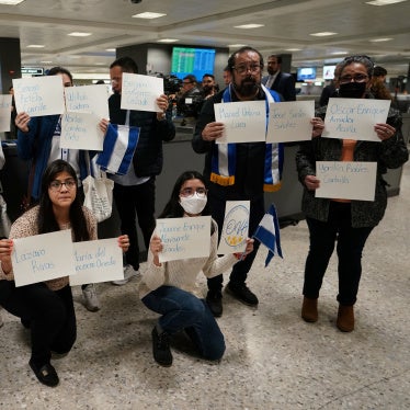 Activists hold signs with the names of some of the 222 former prisoners released and expelled by the Nicaraguan government, as they await their arrival at Dulles International Airport, Virginia, United States, February 9, 2023.