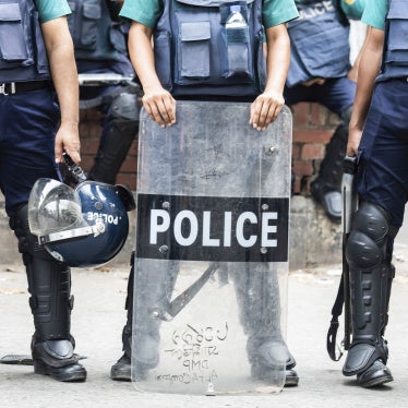 Non-identifiable police officers holding riot shields