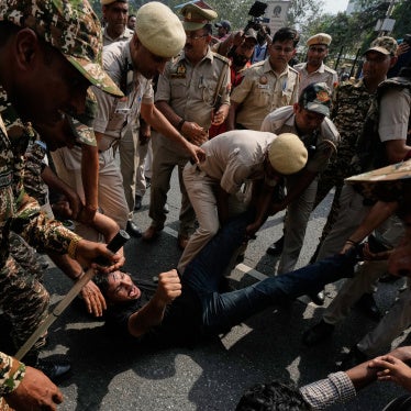 Police detain protesters during a demonstration 