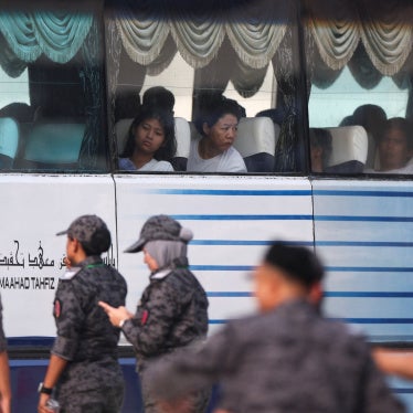 Myanmar nationals to be repatriated from Malaysia sit inside a bus, at Lumut, Malaysia, September 29, 2026.