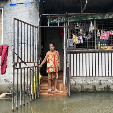 Aidaliza Aquino spends most of her time indoors because of the daily flooding at the Pulo relocation site in Barangay Candelaria, Macabebe, Pampanga, Philippines, July 13, 2026. 