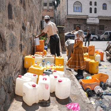 People fill jerrycans with water at a distribution point in Taizz, Yemen, October 20, 2026.