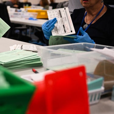 US election workers open and inspect mail-in ballot envelopes during processing inside the Maricopa County Tabulation and Election Center (MCTEC) on Election Day, November 5, 2024, in Phoenix, Arizona.