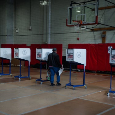 A voter carries a ballot during early voting in the New York City mayoral elections on October 25, 2025.