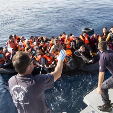 Members of the Hellenic Coast Guard rescue migrants and asylum seekers from an overcrowded rubber dinghy found drifting in the sea off Lesbos island in Greece.  October 4, 2015.