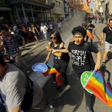 LGBT rights activists run as riot police use a water cannon to disperse them before a Gay Pride Parade in Istanbul, Turkey, on June 28, 2015.