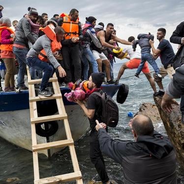 Asylum seekers and migrants descend from a large fishing vessel used to transport them from Turkey to the Greek island of Lesbos. October 11, 2015. 