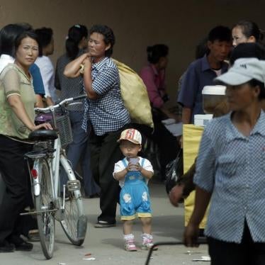 A woman carries goods from a local market at North Korean Special Economic Zone of Rason city, located northeast of Pyongyang on September 2, 2011.