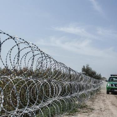 Hungarian police patrol the border with Serbia in Röszke, Hungary. The Hungarian government put up the razor-wire fence in an effort to stem the flow of refugees and migrants into Hungary. September 3, 2015.