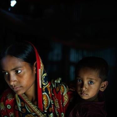 Belkis, 15 years old, holds her one-year-old son in her mother’s house which she returned to after the husband she was married to at age 13 abandoned her. 