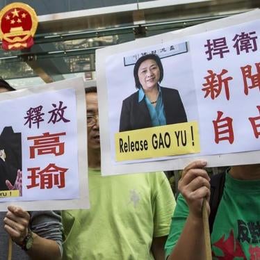Pro-democracy protesters in Hong Kong hold up signs during a demonstration calling for the release of Chinese journalist Gao Yu on April 17, 2015.