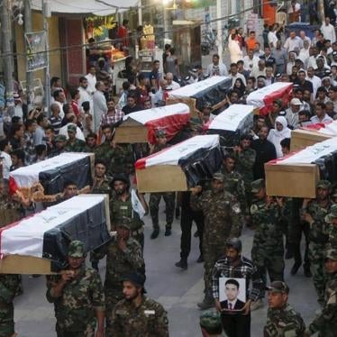  Members of Shi'ite group Asa'ib Ahl al-Haq carry the remains of Shi'ite soldiers from Camp Speicher, who were killed last summer by Islamic State militants, during the funeral ceremony in Najaf, south of Baghdad on July 1, 2015. 