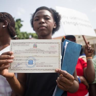 Elena Lorac, a spokesperson from the Reconoci.do movement, shows a birth certificate issued by the Central Electoral Board, during a rally in front of the Presidential Palace in Santo Domingo, July 12, 2013. 