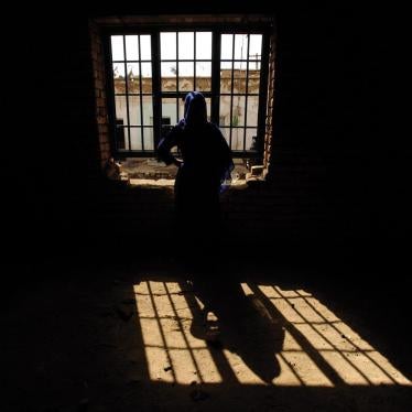 A woman prisoner looks out a window in Parwan prison north of Kabul, Afghanistan, in February 2011. The woman was convicted of moral crimes after a man from her neighborhood raped her. She later gave birth in prison.