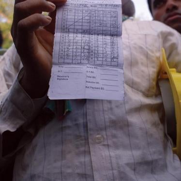 Migrant workers in Manama show their monthly timecards indicating hours they worked, but for which, they say, they have not been compensated. Unpaid wages is one of the most common human rights abuses migrant workers face.
