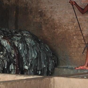A boy soaks hides in a pit of diluted chemicals in a Hazaribagh tannery. International law binding on Bangladesh, as well as Bangladesh’s own labor law, prohibits employing children under 18 in harmful or hazardous work. Dhaka, June 2012.
