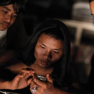 A worker uses a mobile phone in Burma, where the government plans to increase mobile access to 50 percent in three years.