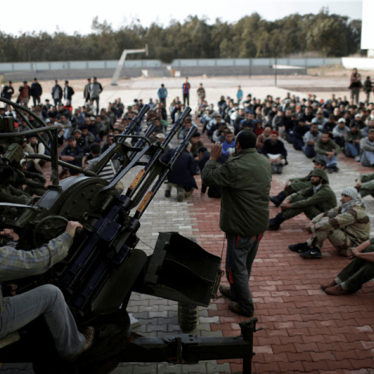 Libya rebel fighters are shown how to use an anti-aircraft gun