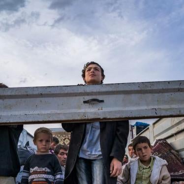 SEPTEMBER 2014. Syrian Kurdish refugees look out from the back of a truck as they enter Turkey from the town of Kobane (Ayn al-Arab), Syria, and surrounding villages. © 2014 Michael Christopher Brown/Magnum