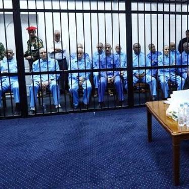 Libyan former head of intelligence Abdullah Sanussi sits behind bars together with other suspects during their trial at a courtroom in Tripoli, Libya, on November 16, 2014. 