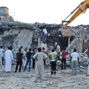 Relatives and neighbors search for survivors in the rubble of the Gafez family home in Majer on August 9, 2011, one day after NATO strikes on this and another compound killed 34 people and wounded more than 30.