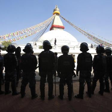 Nepalese police stand guard at the premises of the Boudhanath Stupa after a Tibetan monk self-immolated in Kathmandu on February 13, 2013.