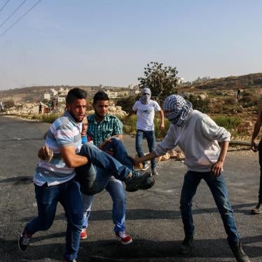 Palestinian youth evacuate an injured Palestinian man shot by Israeli forces at a protest in Ramallah. October 5th, 2015.