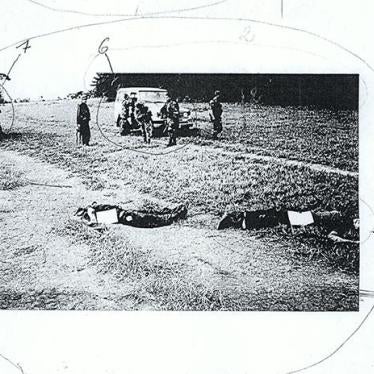 Photocopy of a photograph of the dead bodies of two victims of alleged false positive killings committed in Meta department in 2004, with army troops in the background.