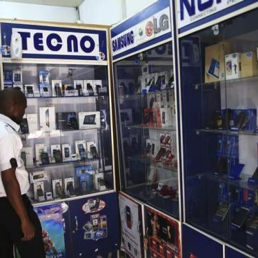 A man looks at smartphones on display at a shop at Wuse II business district in Abuja, Nigeria, December 9, 2014.