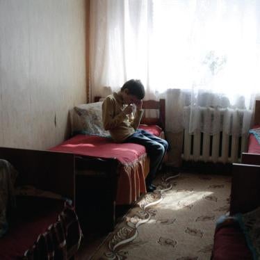 A boy sits in his room at a state boarding school