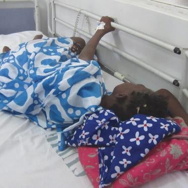 During a morphine shortage, a cancer patient in Dakar clutches onto the railing of her hospital bed because she is in pain and the medication she needs is unavailable.