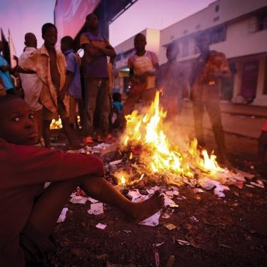 Street children in Mbale town in Uganda, 140 miles east of the capital, Kampala, surround an open fire to stay warm at night.
