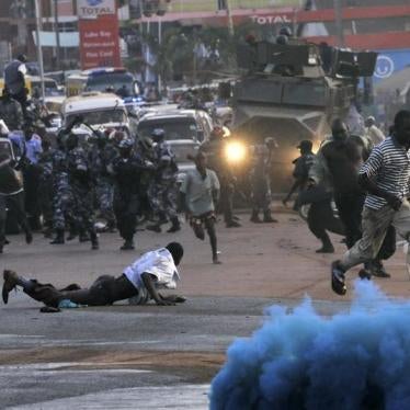 Anti-riot police fire canisters of colored teargas to disperse supporters of opposition Forum for Democratic Change during a procession to welcome their leader Kizza Besigye in Kampala on May 12, 2011.