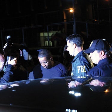 Federal agents and police escort James Cromitie (center) from the FBI’s New York headquarters on May 21, 2009.