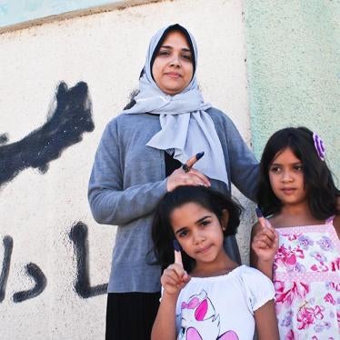 Manal Ameer, 33, pictured here with her two daughters, was among the first to vote in Benghazi.
