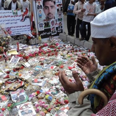 A ceremony honoring those killed in the Friday of Dignity massacre in Sanaa, Yemen, on March 18, 2011, held one week later at the site of the killings.  The text on the posters contains a prayer and names of the dead.