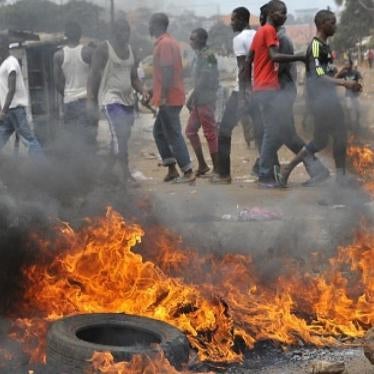 Tires burn during a clash on April 13, 2015 in the capital, Conakry, between policemen and Guinean opposition supporters.  The protesters clashed with security forces over a dispute with the government over the timing of both local and presidential electi