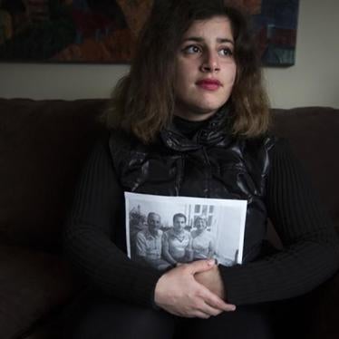2015年11月22日在美国新泽西州奥克兰， 刚逃离叙利亚的难民桑迪怀抱着仍留在叙利亚的家人照片留影。