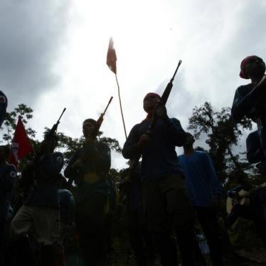 Members of the New Peoples Army (NPA), armed group of the Communist Party of the Philippines, are silhouetted during graduation after their military training in their jungle hideout in Lianga in southern Mindanao island March 13, 2004.