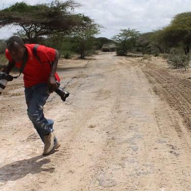 Somali photojournalist runs for cover while reporting on fighting between the Somali government and African Union forces against the Islamist armed group Al-Shabab in the Lower Shabelle region of Somalia, April 2012.