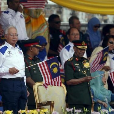 Malaysia's (L-R) Prime Minister Najib Razak and King Abdul Halim Mu'adzam Shah wave Malaysian national flags during National Day celebrations in Kuala Lumpur, August 31, 2015.