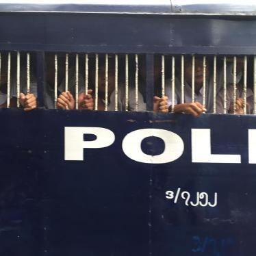 Police vans bring detained student protesters from the district courthouse to Tharrawaddy prison in Pegu region on October 27, 2015. 