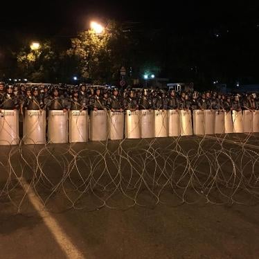 Riot police and barbed wire block protestors from marching down Baghramyan Street in downtown Yerevan on July 30, 2016. 