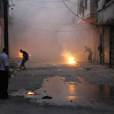 At least four incendiary submunitions burn on the ground of a narrow street in the al-Mashhad neighborhood of opposition-held east Aleppo city immediately after an incendiary weapon attack on August 7, 2016.