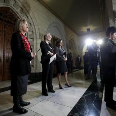 Canada's Indigenous Affairs Minister Carolyn Bennett (L), Status of Women Minister Patricia Hajdu (2nd L) and Justice Minister Jody Wilson-Raybould look on as Algonquin leader Claudette Commanda (R) says a prayer at the start of a news conference