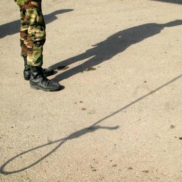 Shadows of an Iranian policeman and a noose are seen on the ground before an execution in Pakdasht, south of Tehran, March 2005.