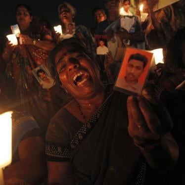 A Tamil woman cries as she holds up an image of her family member who disappeared during the civil war with the Liberation Tigers of Tamil Eelam (LTTE) at a vigil to commemorate the international day of the disappeared in Colombo August 30, 2013.